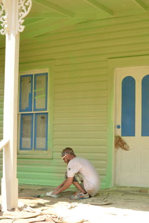 Michael Willetts of Johns Painting prepares to paint one of the structures at the Historic Village.